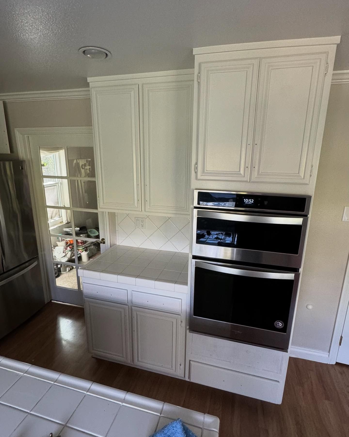 A kitchen with white cabinets and stainless steel appliances.