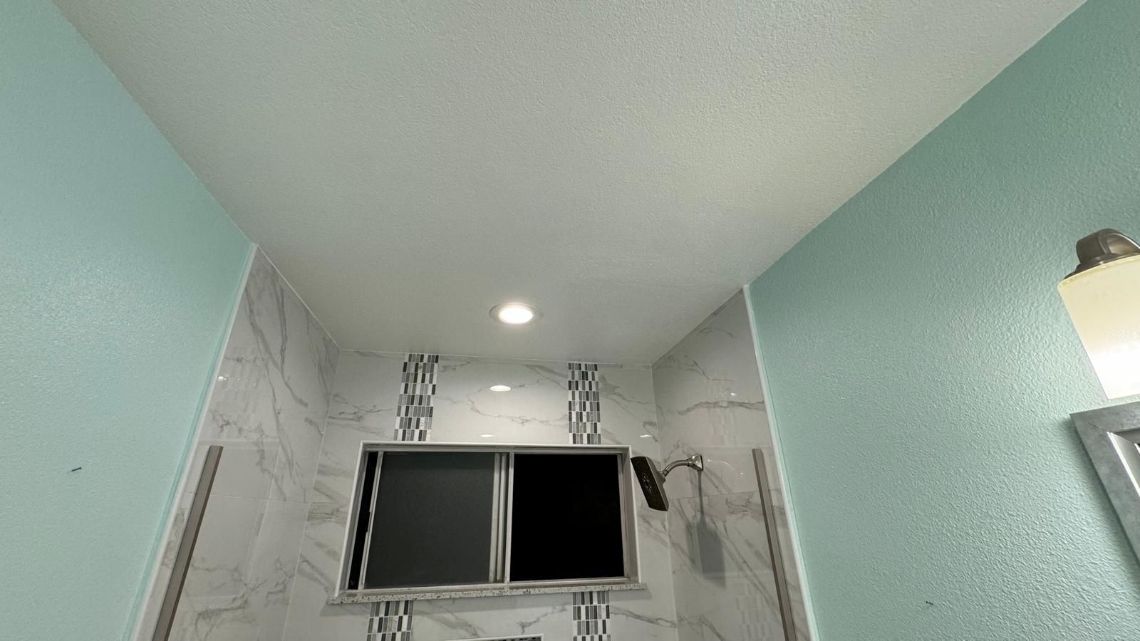 A living room with hardwood floors , a fireplace and stairs.