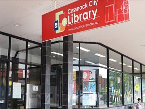 The cessnock city library is located on the corner of a building.