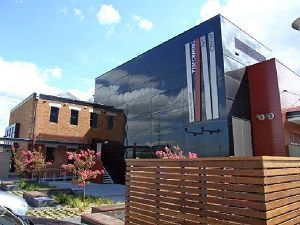 A large building with a wooden fence in front of it.
