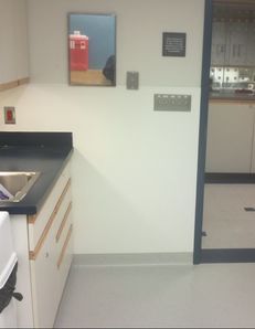 A kitchen with a sink and a mirror on the wall