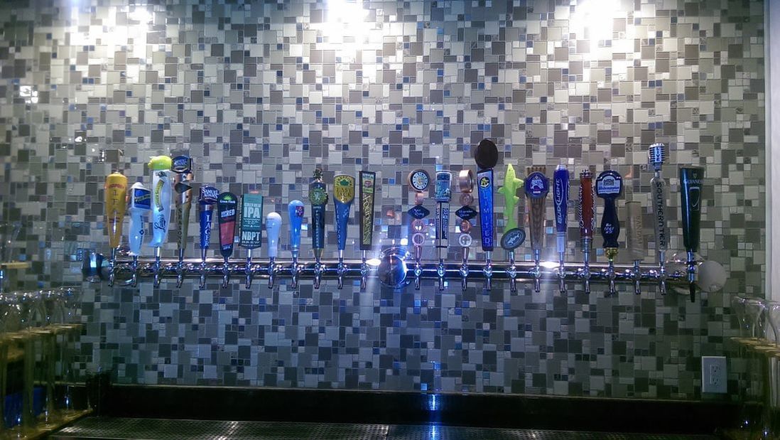 A bar with a lot of beer taps on it.