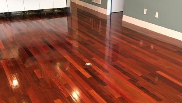 A close up of a wooden floor in a room.