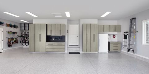 Grey walk-in closet with desk area. Includes hanging clothes, shelves, and a chair.