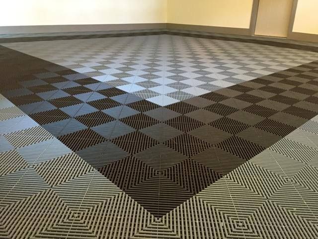 Empty room with a black, gray, and tan geometric carpet pattern