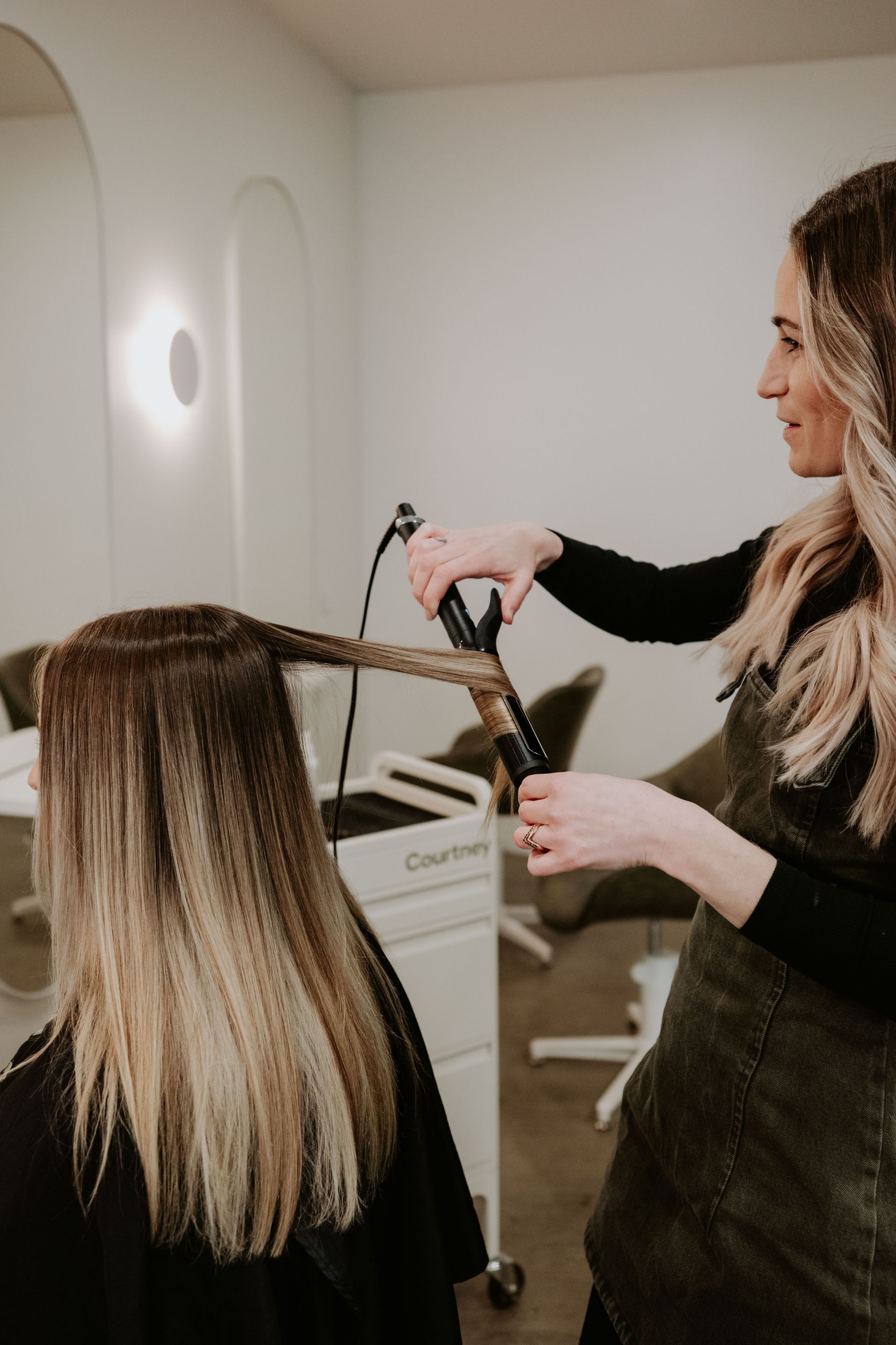 A Woman Is Getting Her Hair Washed In A Sink At A Salon — Rowe Street Collective In Shepparton, VIC