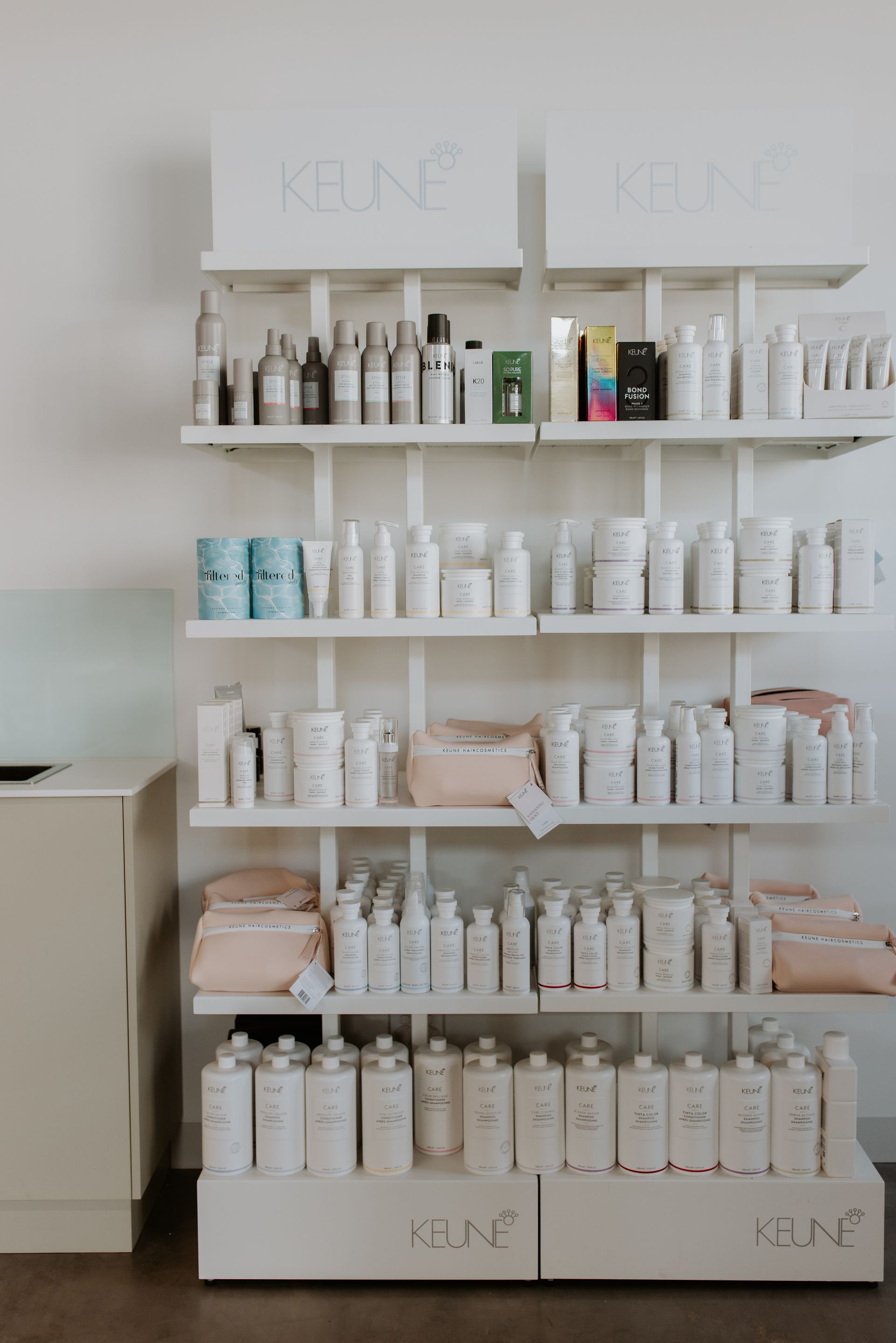 A shelf filled with lots of hair products in a salon. — Rowe Street Collective In Shepparton, VIC
