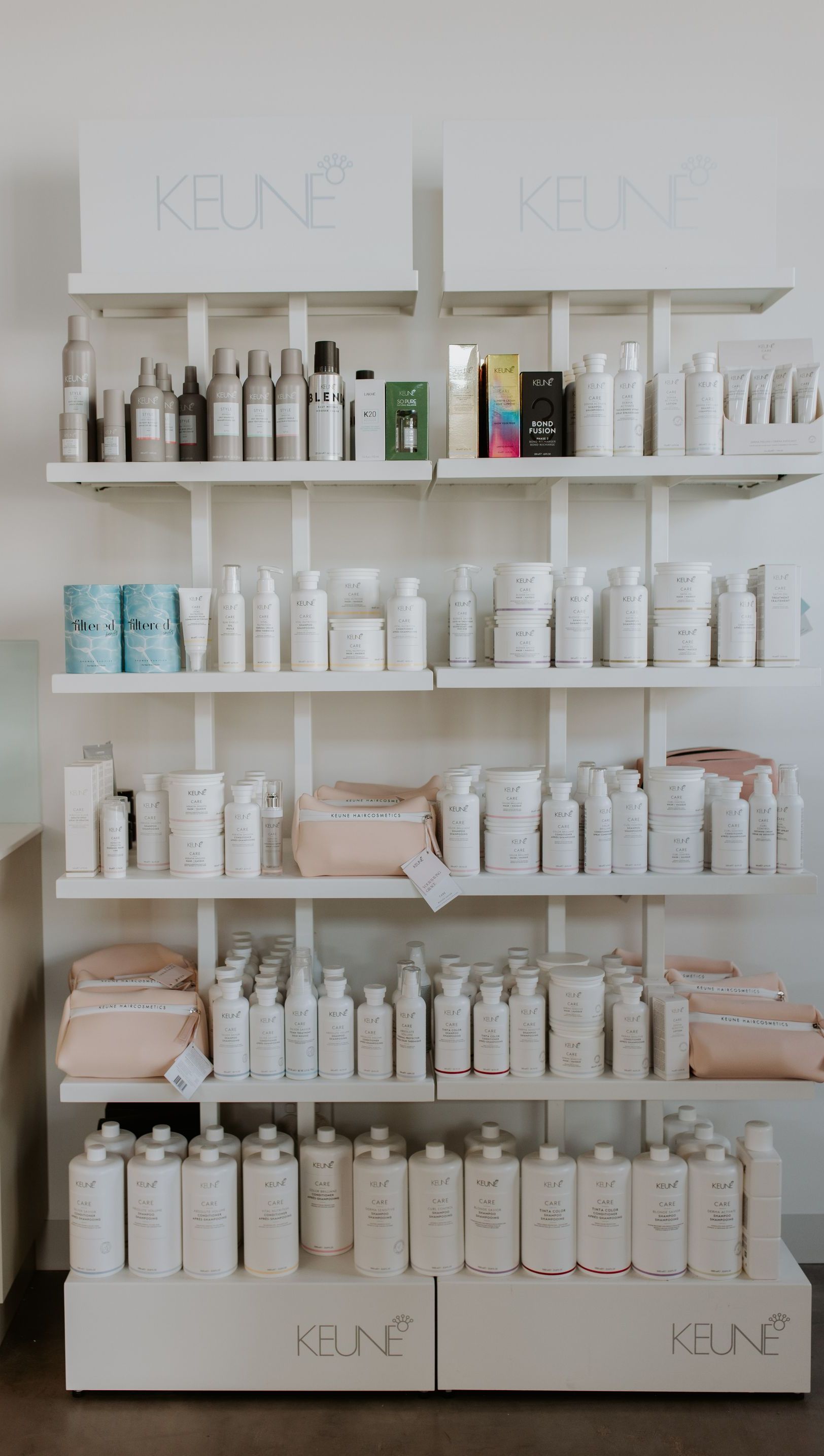 A shelf filled with lots of hair products in a salon. — Rowe Street Collective In Shepparton, VIC