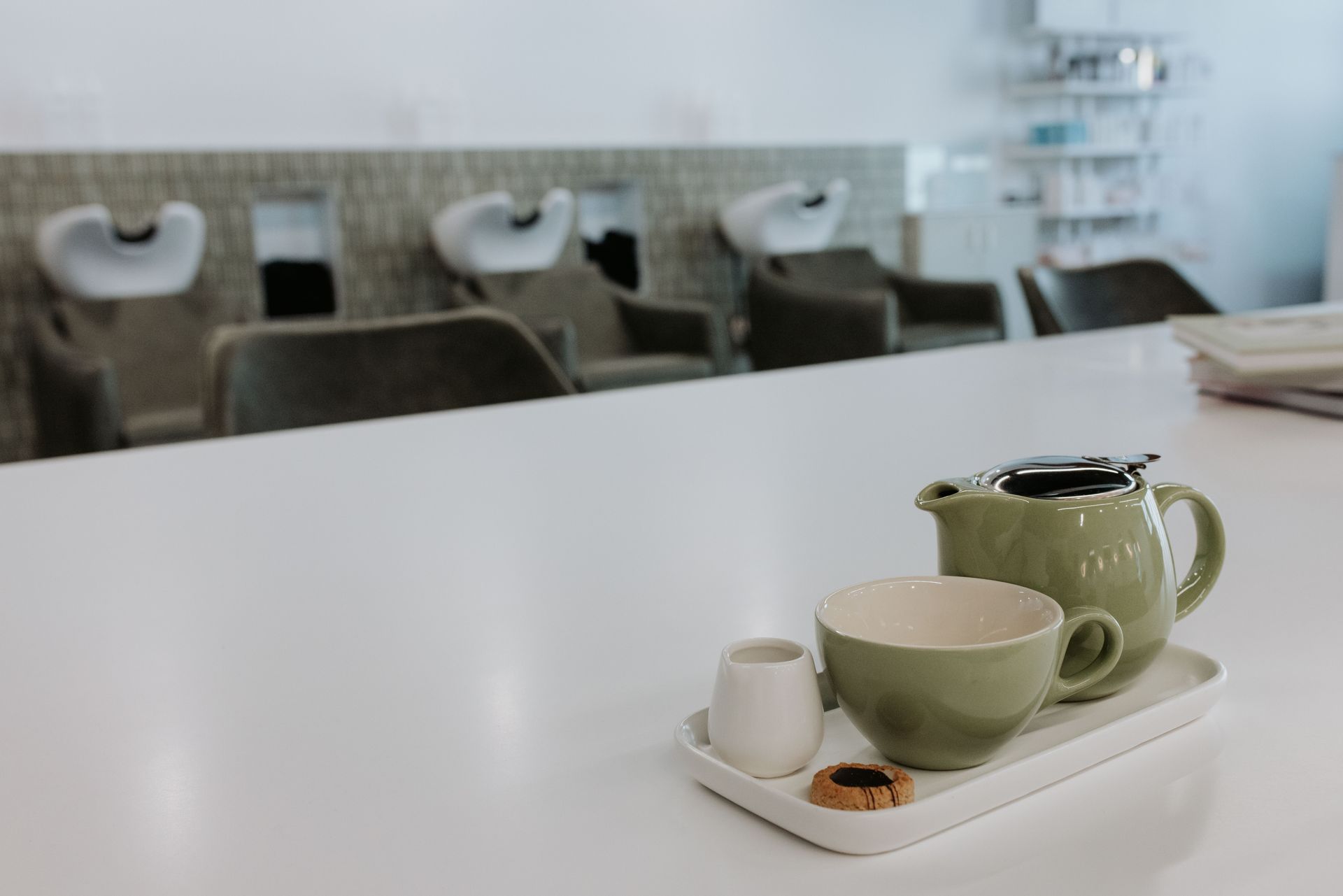 A tray with a teapot , cup and donut on it in a salon. — Rowe Street Collective In Shepparton, VIC