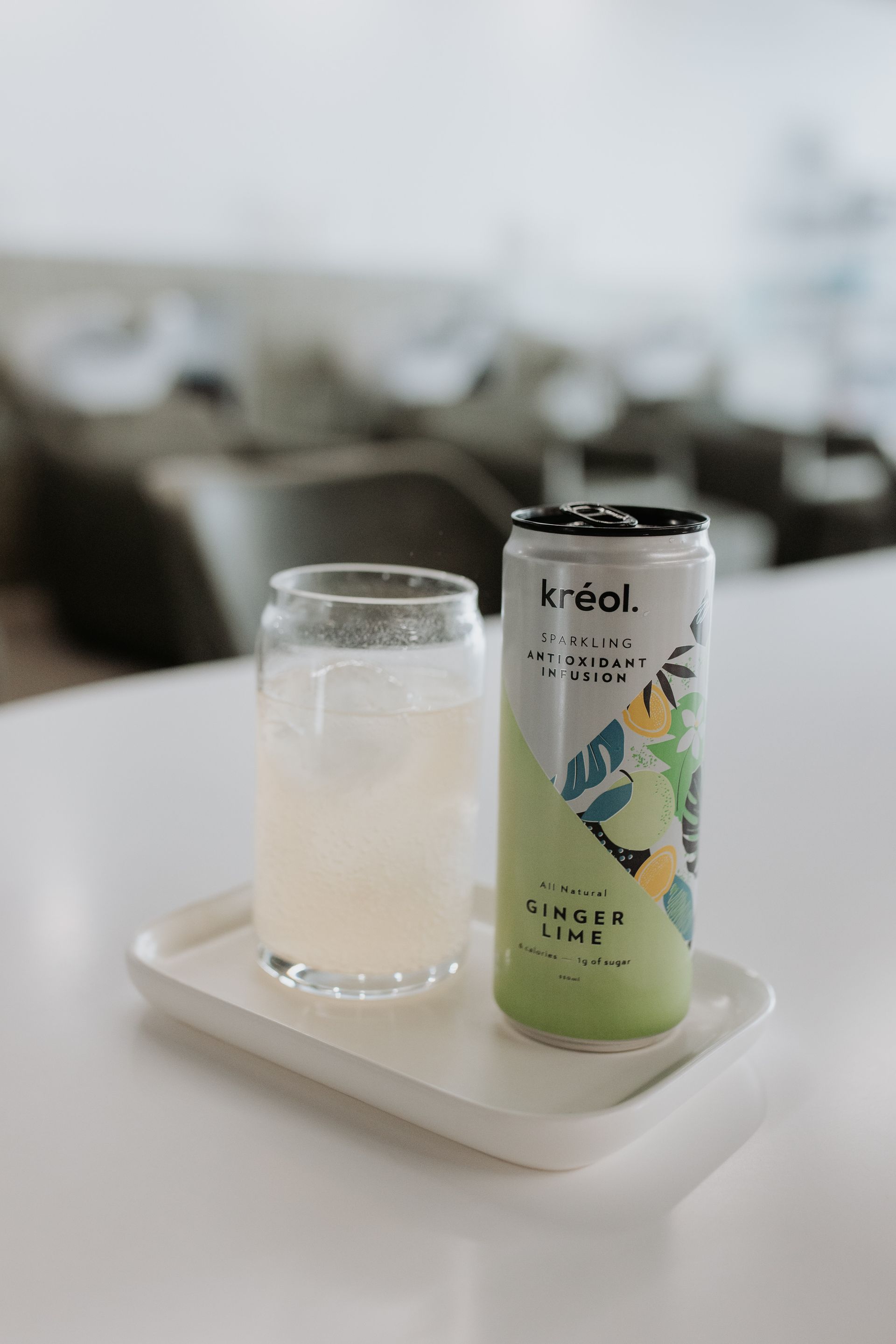 A can of soda and a glass of soda are on a tray on a table. — Rowe Street Collective In Shepparton, VIC