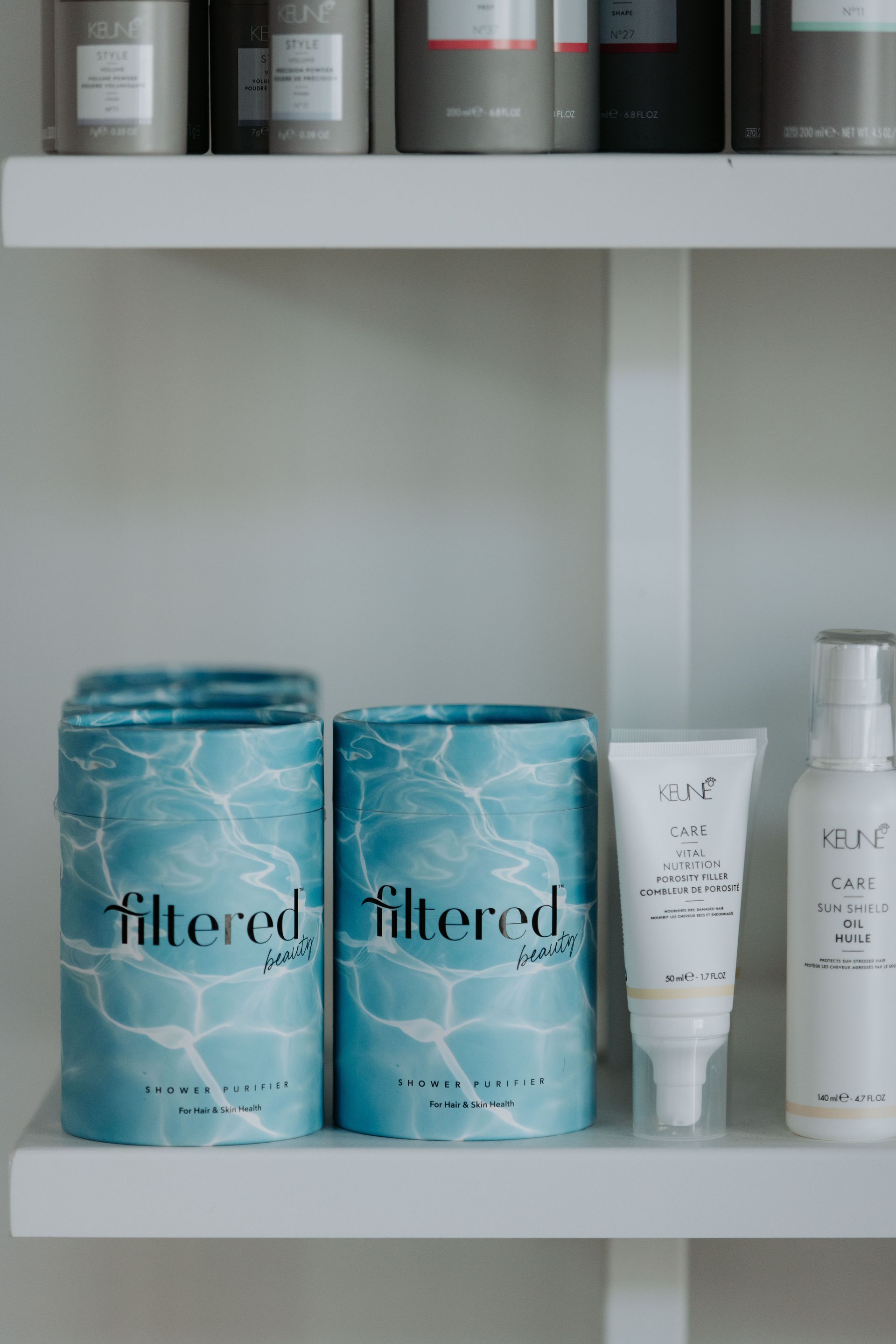 A shelf filled with bottles and containers of cosmetics. — Rowe Street Collective In Shepparton, VIC