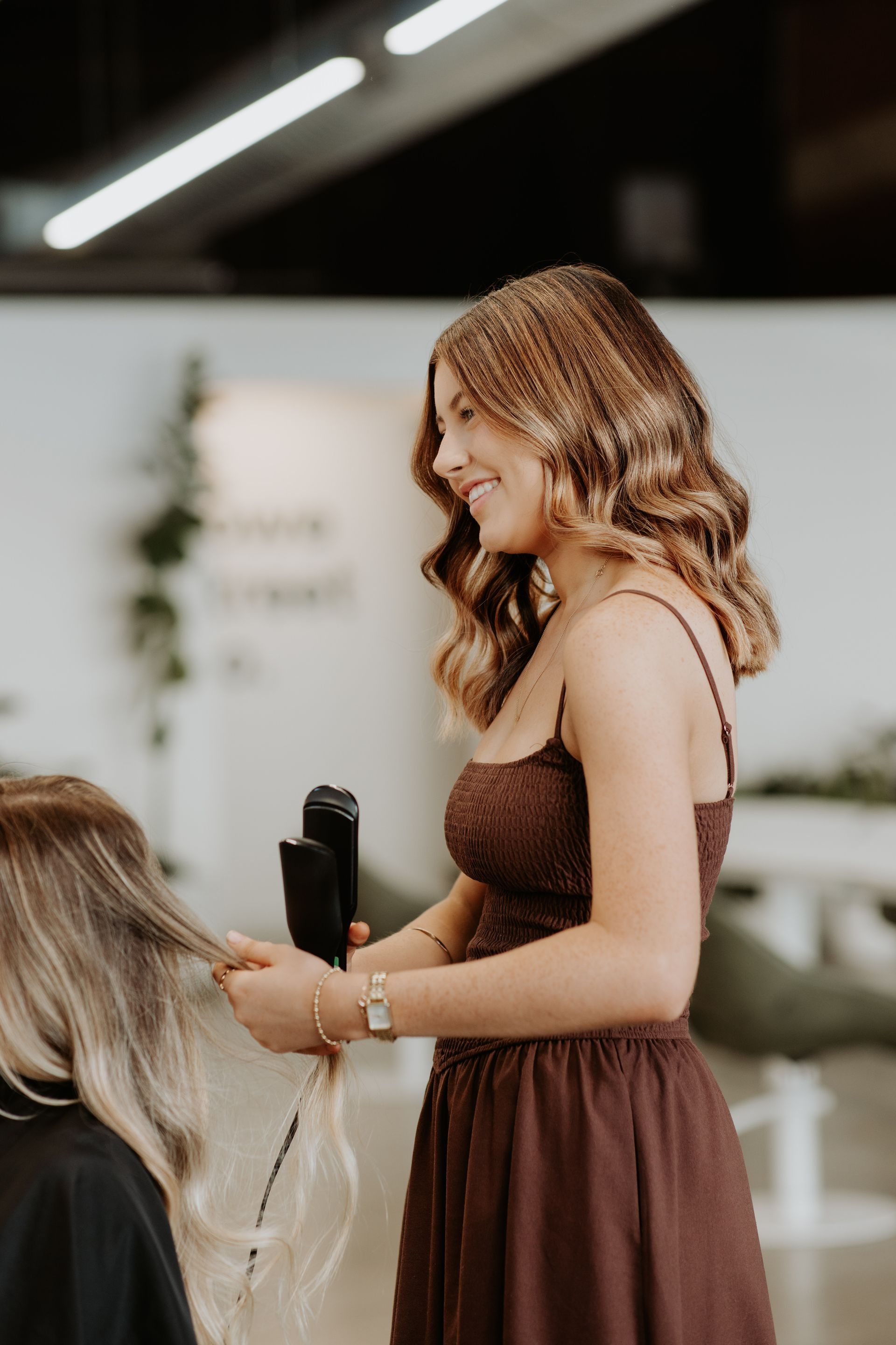 A woman is getting her hair cut by a hairdresser in a salon. — Rowe Street Collective In Shepparton, VIC