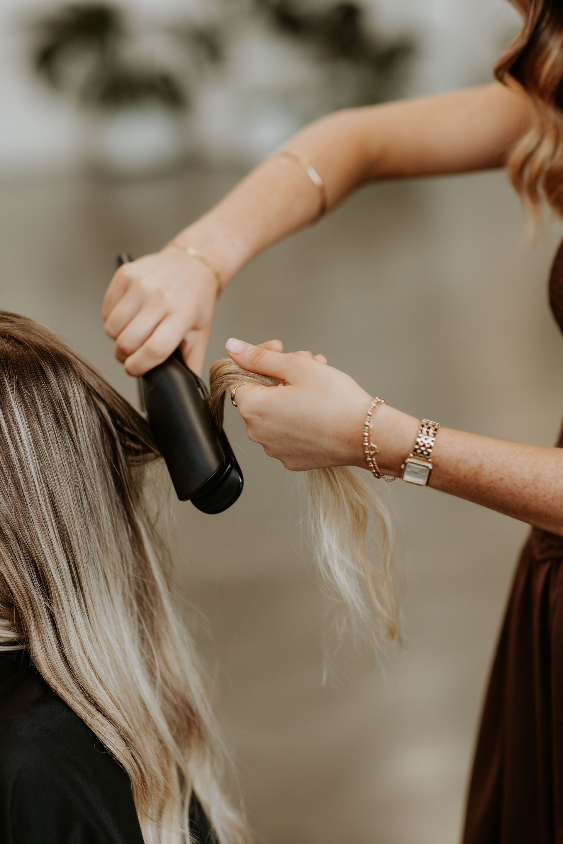 A woman is getting her hair blow dried by a hairdresser in a salon. — Rowe Street Collective In Shepparton, VIC