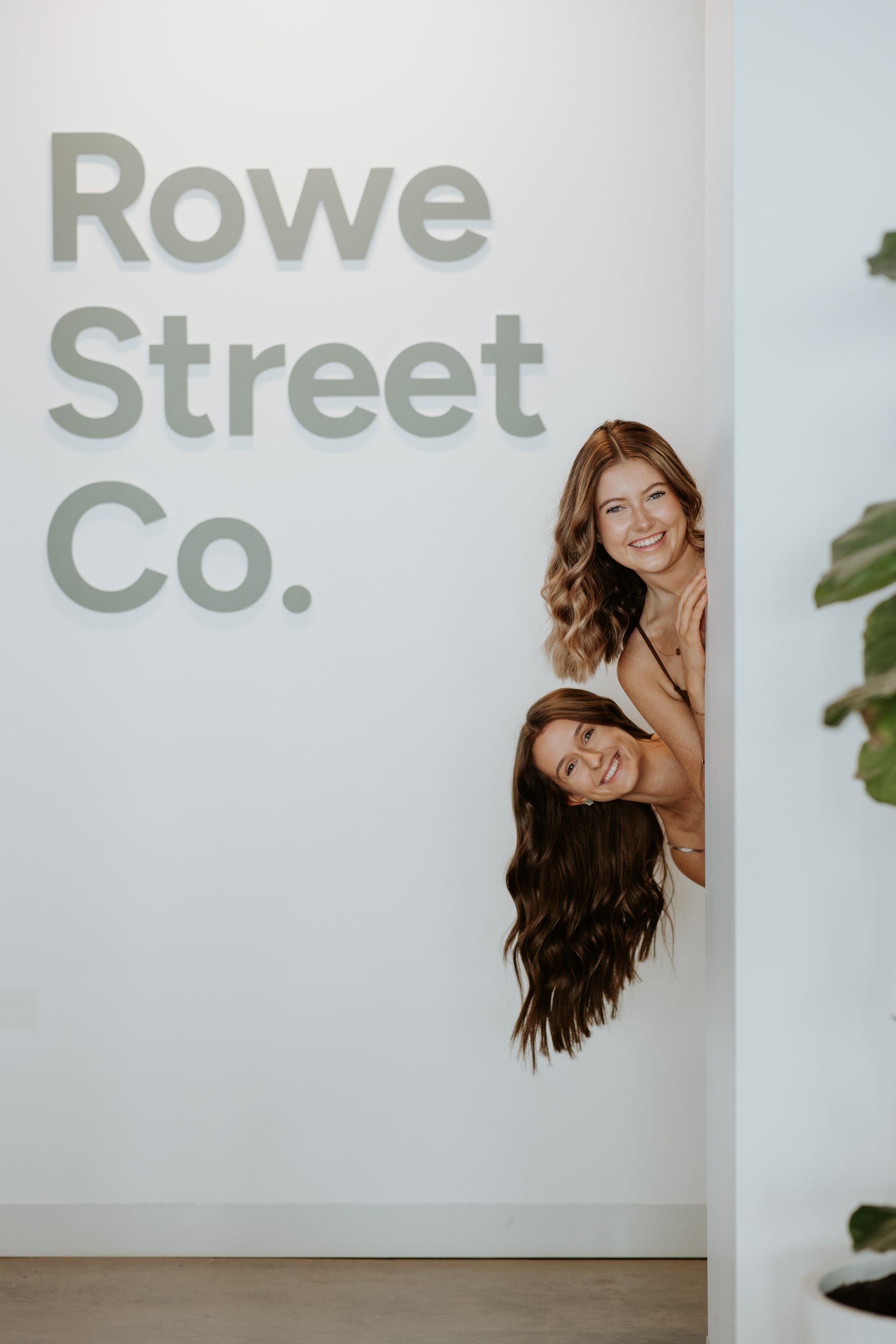 A Woman Is Getting Her Hair Done By A Hairdresser In A Bathroom — Rowe Street Collective In Shepparton, VIC