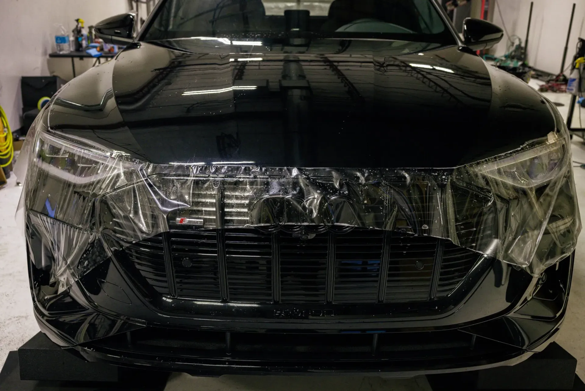 Black car front view with clear film on the front.