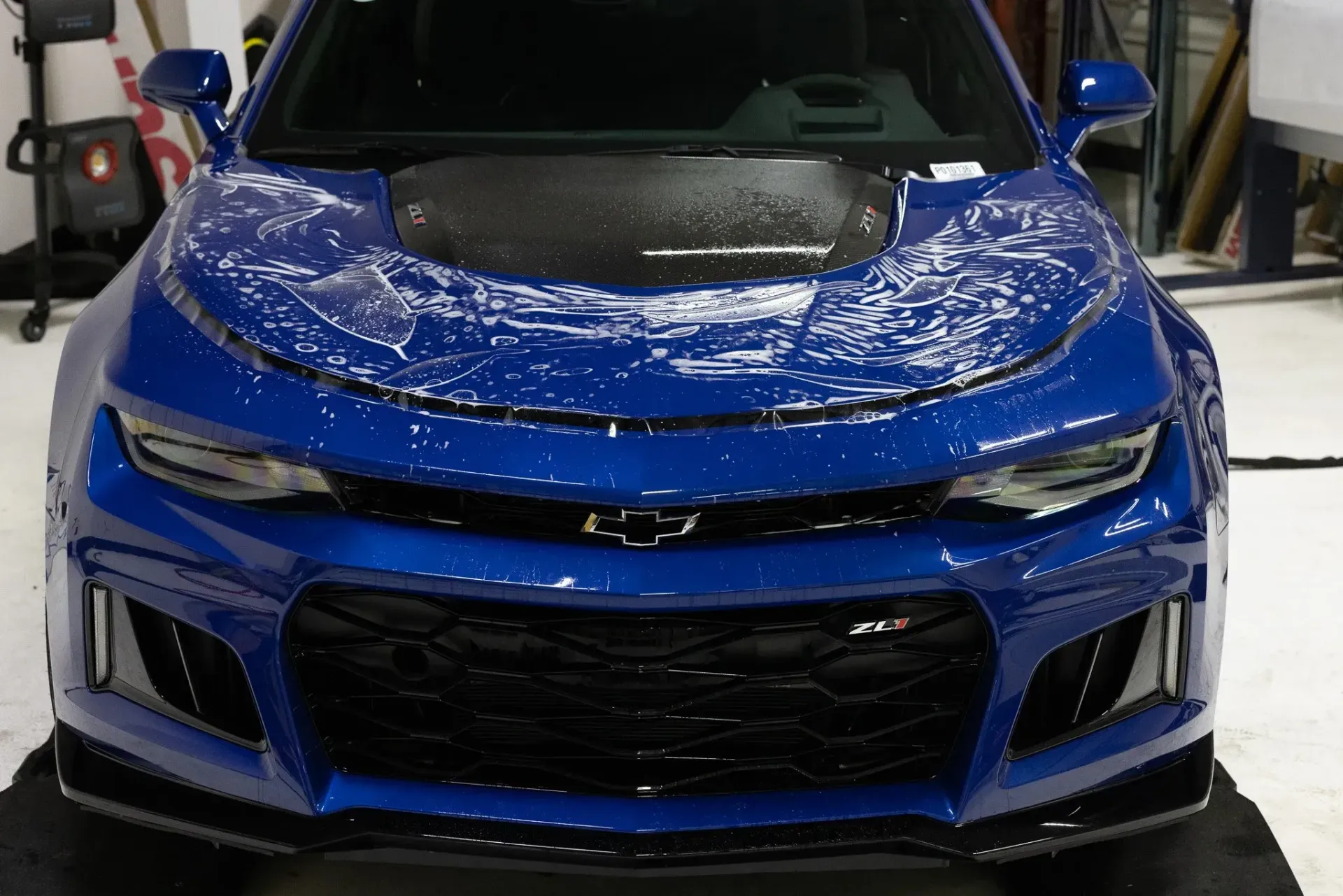 Blue Chevrolet Camaro sports car with a dark hood and black accents.