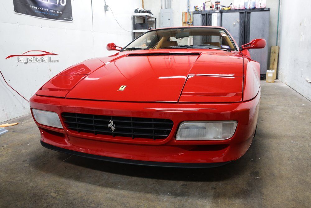 Red Ferrari Testarossa in a garage.