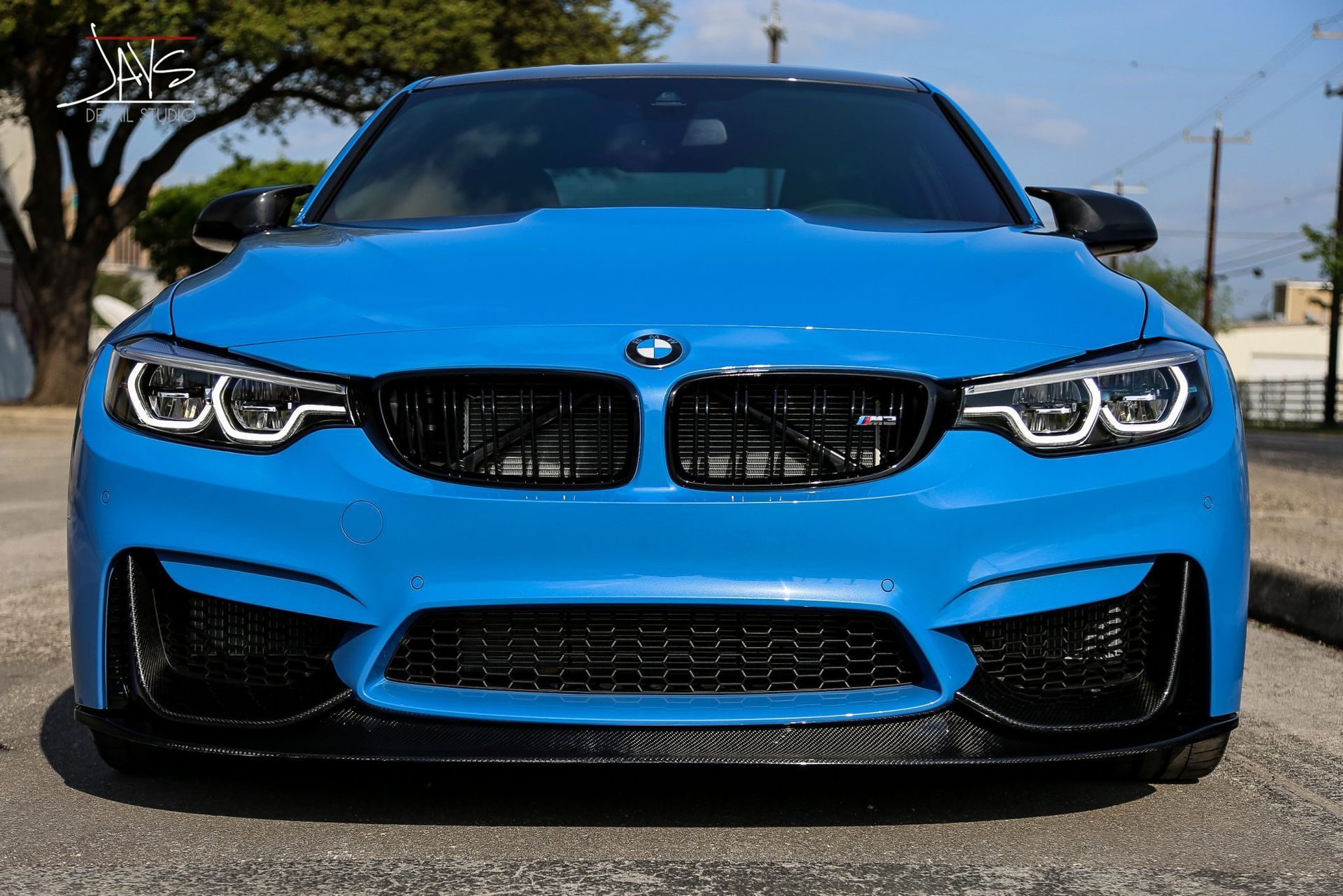Blue BMW sports car, front view, black grill, black accents, bright blue paint.
