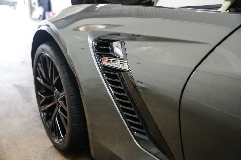 Gray Corvette Z06 front quarter panel with black vent and wheel.