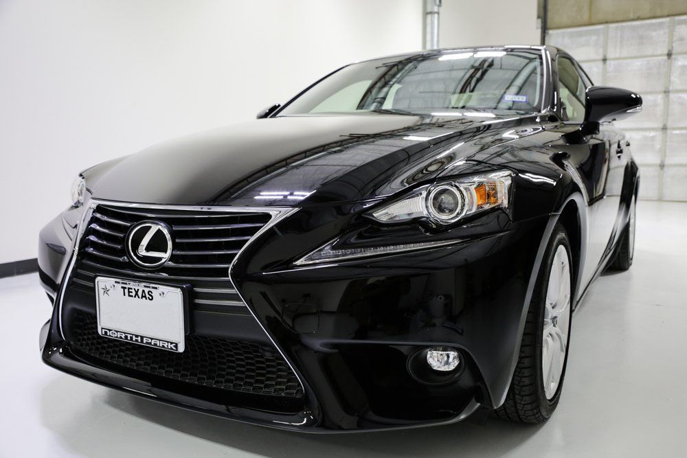 Black Lexus IS sedan, parked inside a well-lit garage.