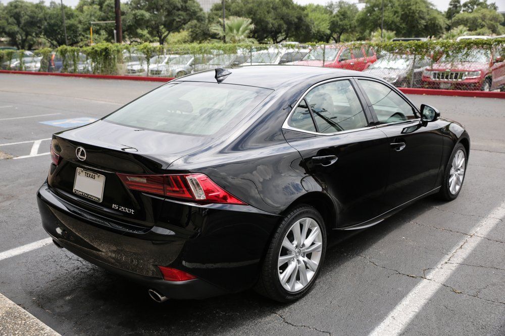 Black Lexus sedan parked in a parking lot, viewed from the rear.