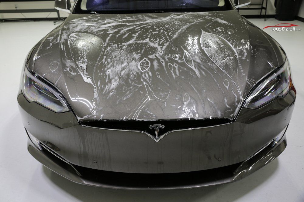 Tesla car with clear protective film on the hood.