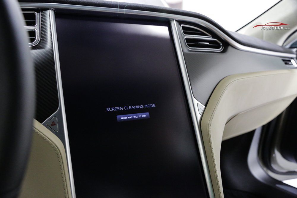 Tesla car interior with large central touchscreen displaying