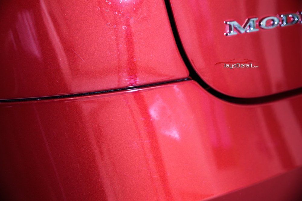 Red car body with liquid dripping down, 