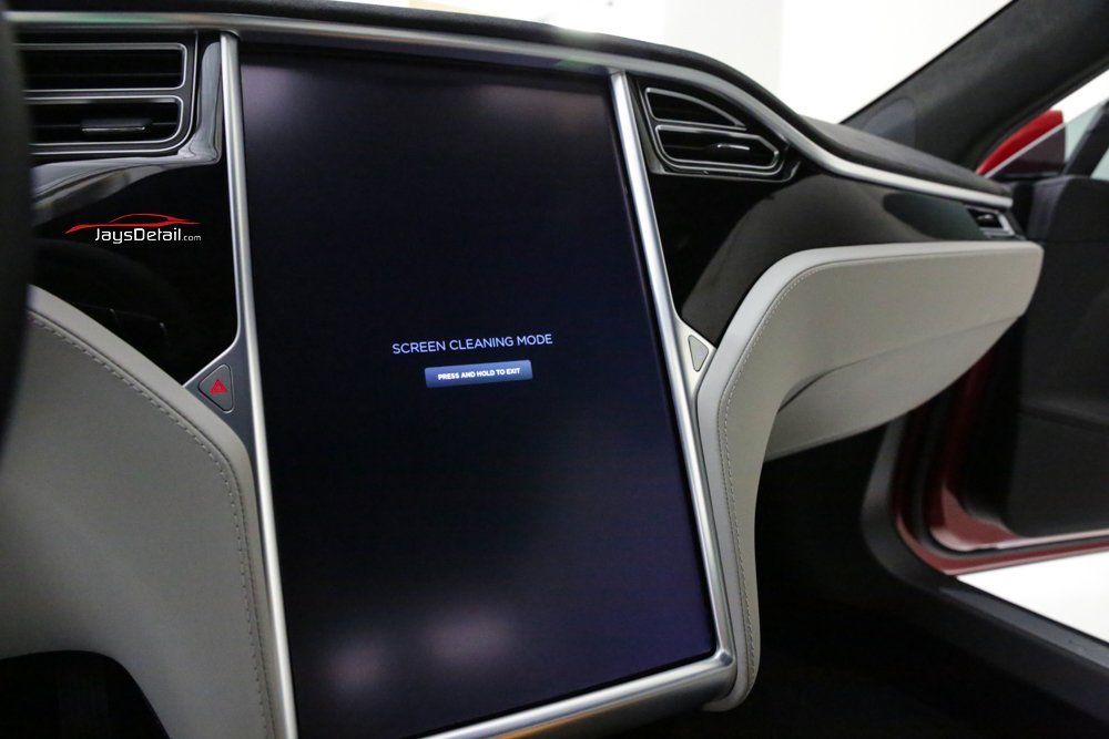 Tesla car dashboard with a blank touchscreen display, and a