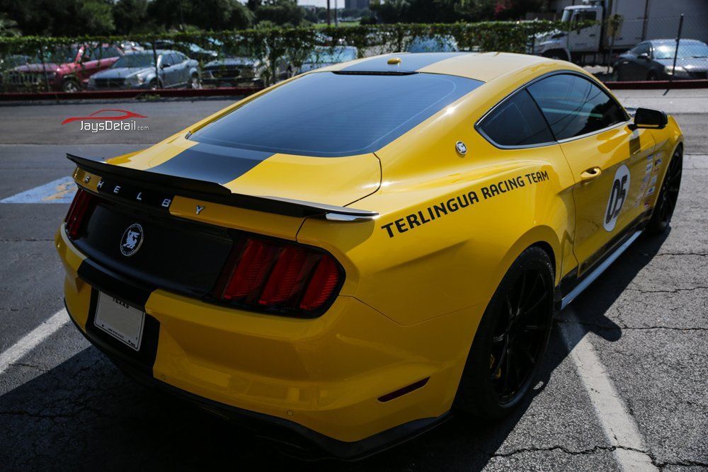 Yellow Ford Mustang with black racing stripe,