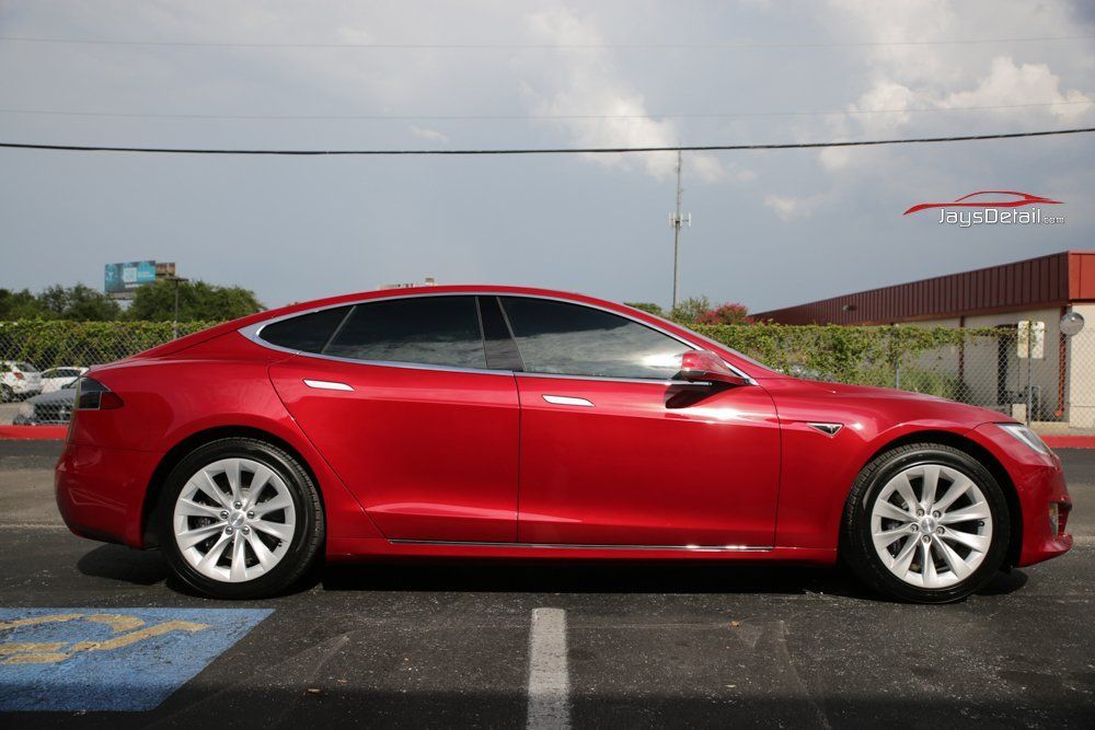 Red Tesla Model S parked outdoors.