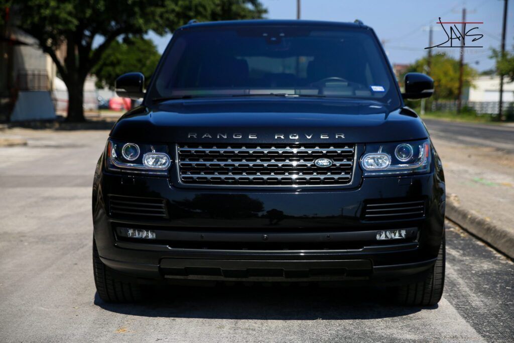 Black Range Rover parked on a street.