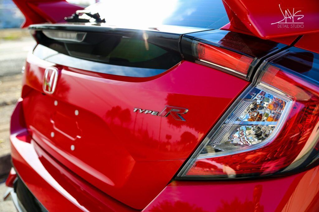 Red Honda Civic Type R rear end with spoiler and taillight.
