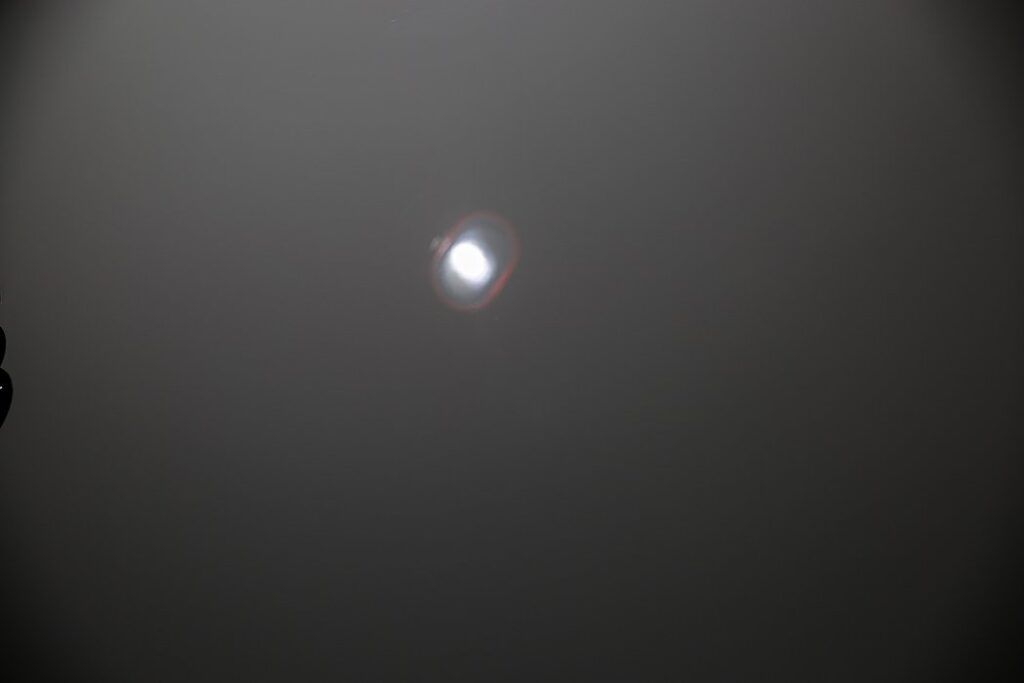 Bright, hazy orb in a dark, gray sky.