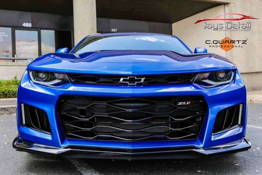 Blue Chevrolet Camaro ZL1 sports car in front of a building.