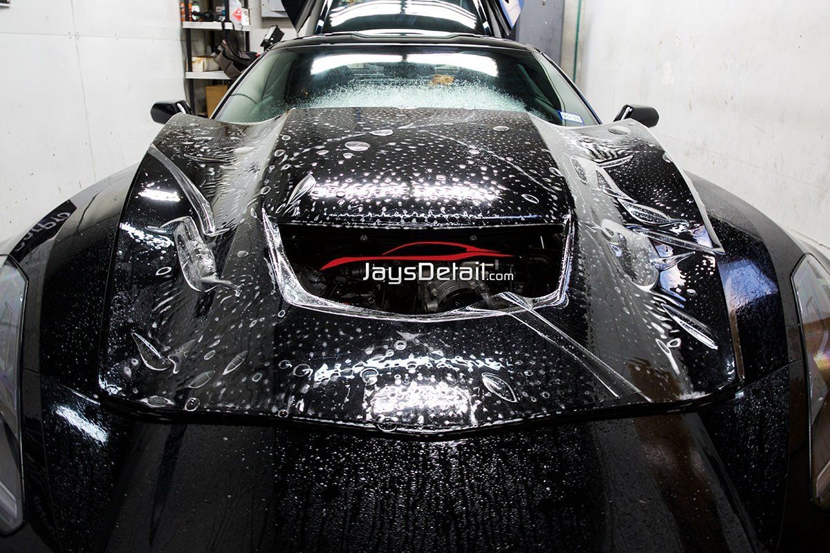 Black car hood with protective film being applied; Jay's Detail logo visible.