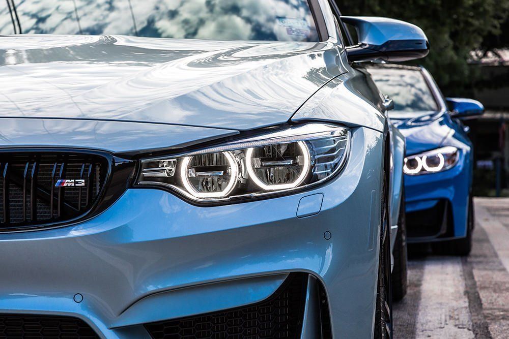 Red Dodge Challenger front quarter panel with a bronze wheel, black tire, and red brake calipers.