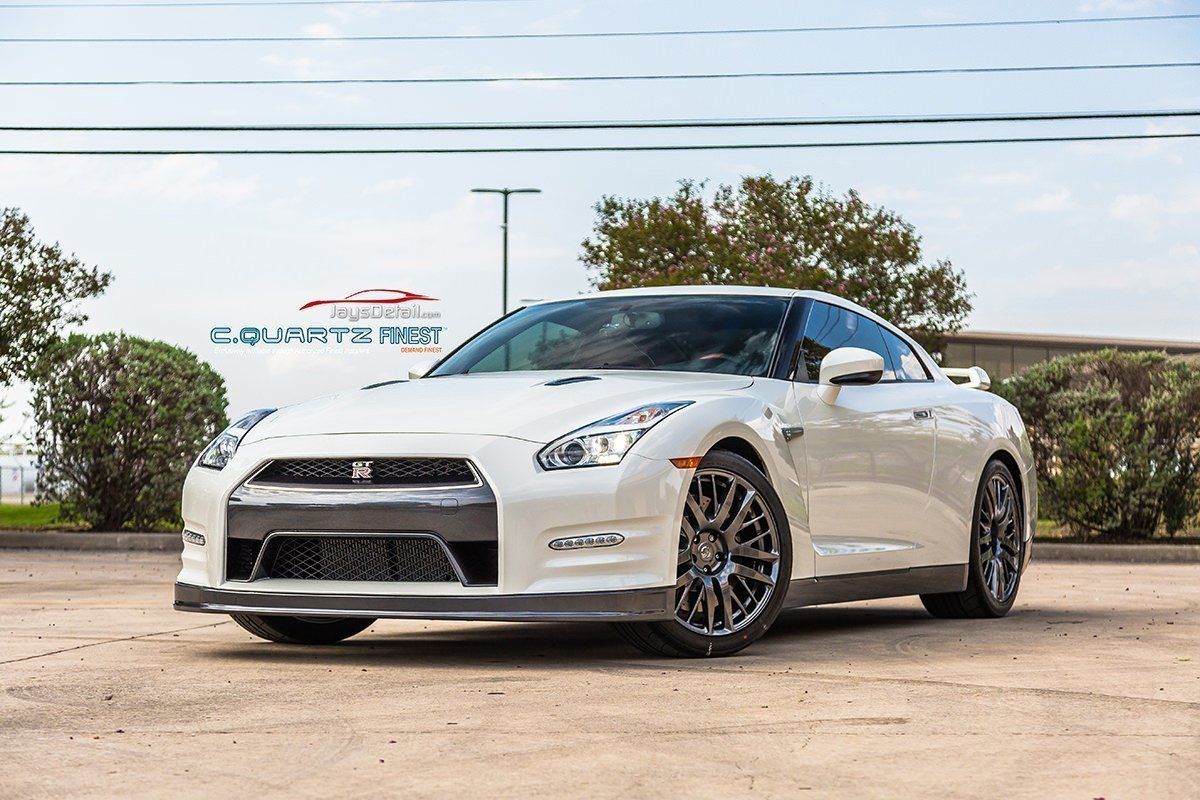 White Nissan GT-R sports car parked outdoors on a sunny day.