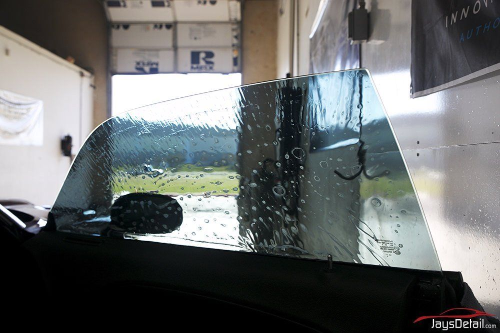 Car window being tinted with blue tint. Interior shot.