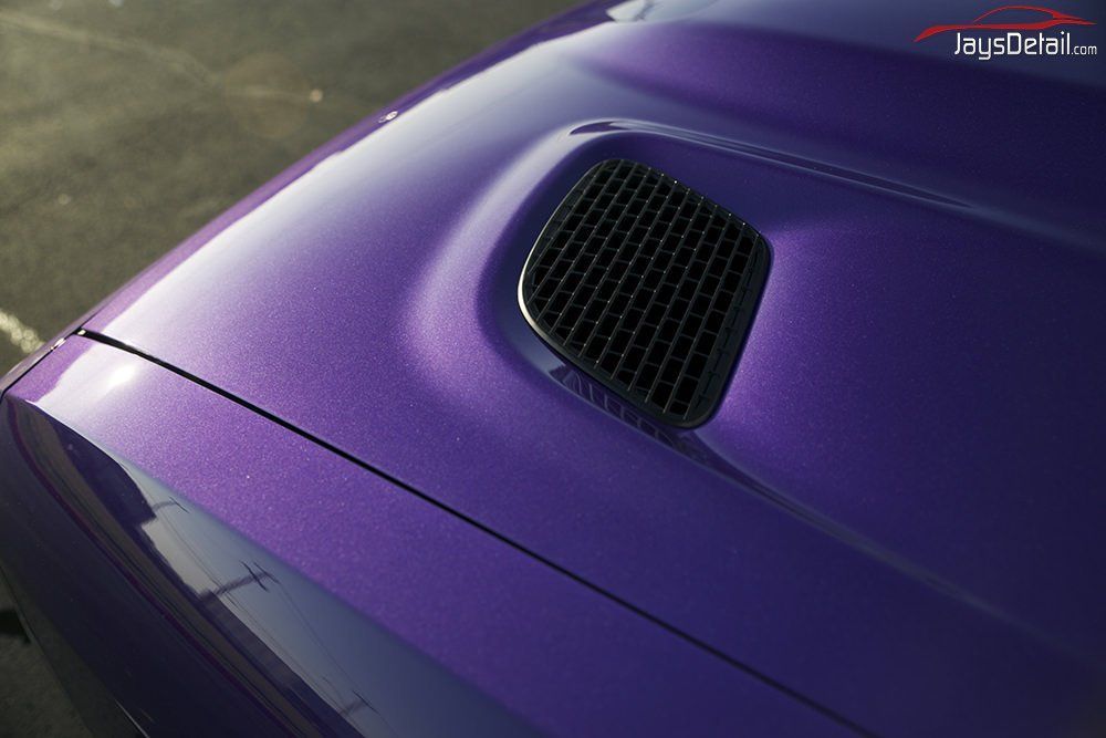 Purple car hood with black air vent.