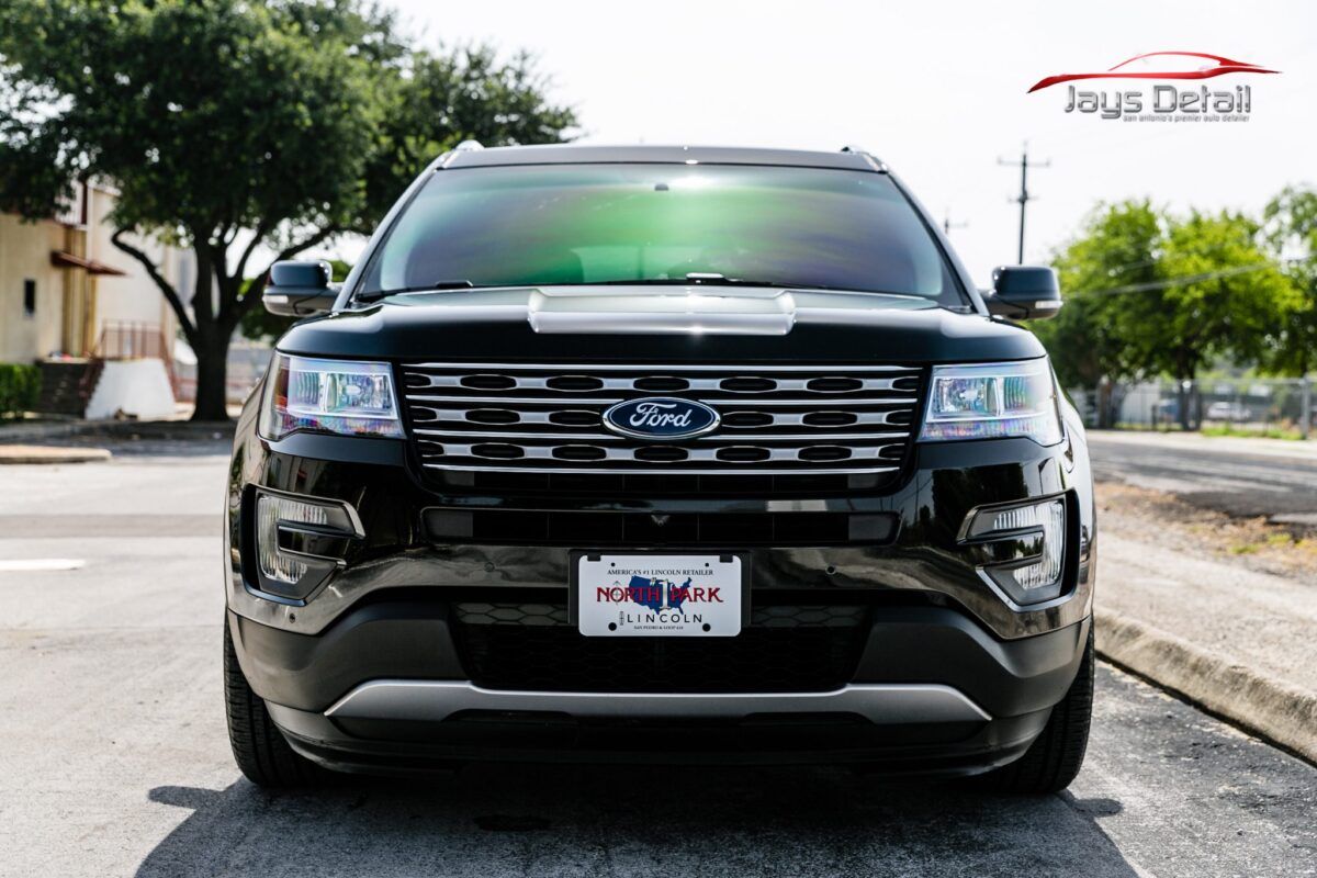 Black Ford Explorer, front view, Texas license plate, sunny outdoor setting.