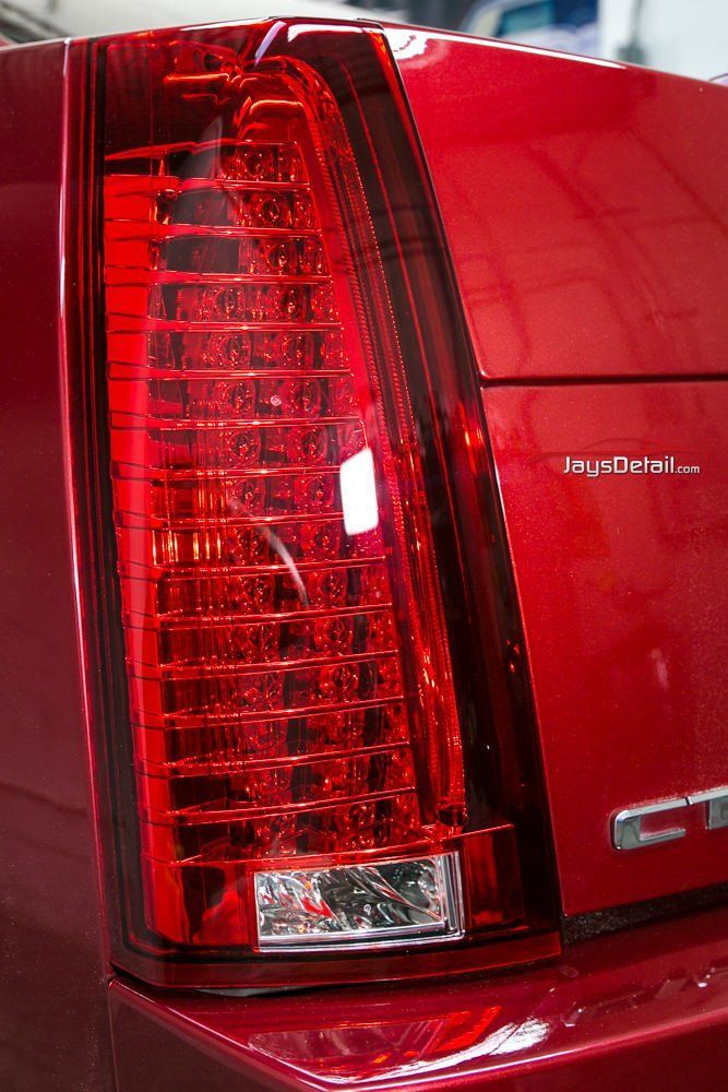 Red Cadillac CTS tail light with vertical LED array and clear lower light.