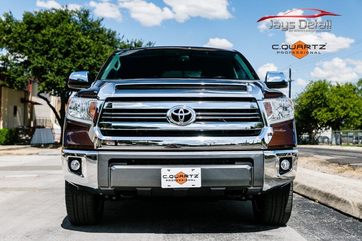 Brown Toyota Tundra truck, chrome grill, parked on the street.