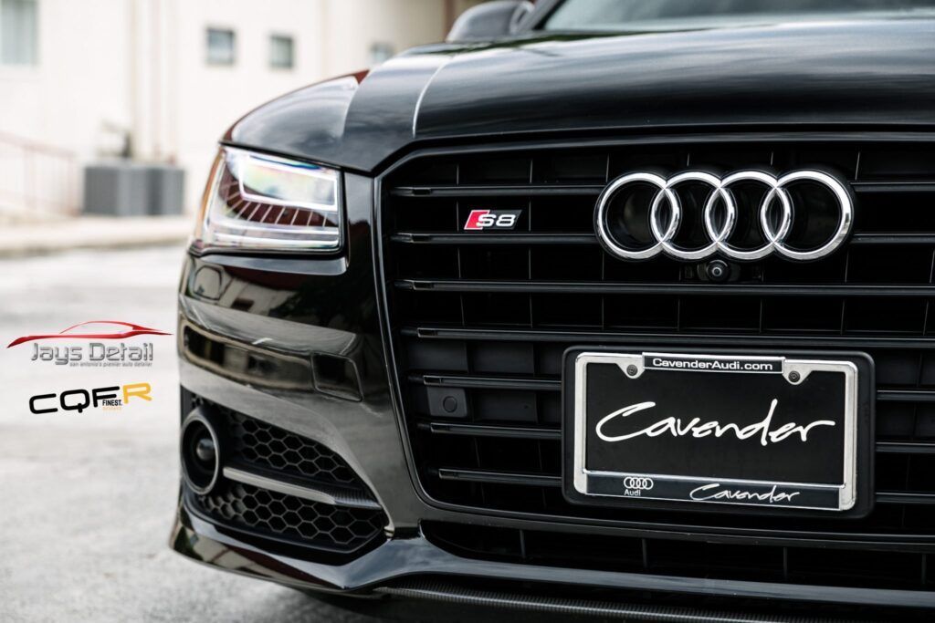 Black Audi car front with grill, license plate reading 'Casondor', and Audi logo.