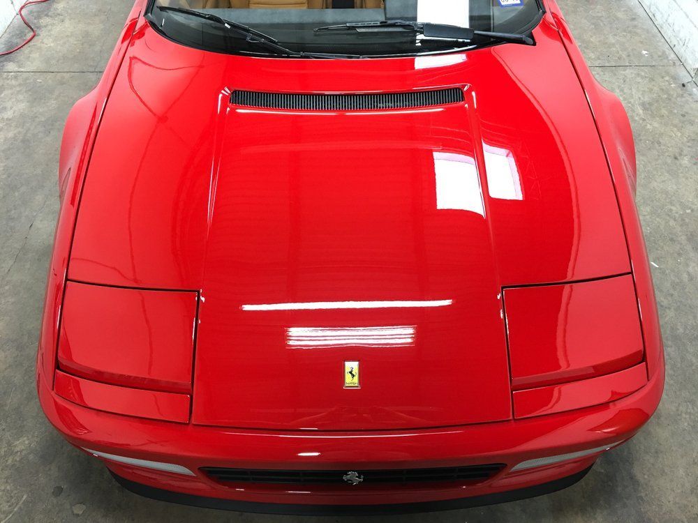 Bright red Ferrari Testarossa with pop-up headlights, viewed from above.