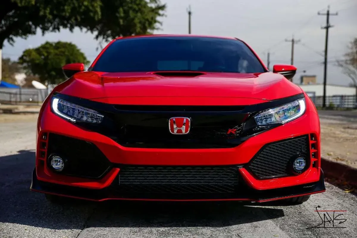Red Honda Civic Type R with black accents, front view.