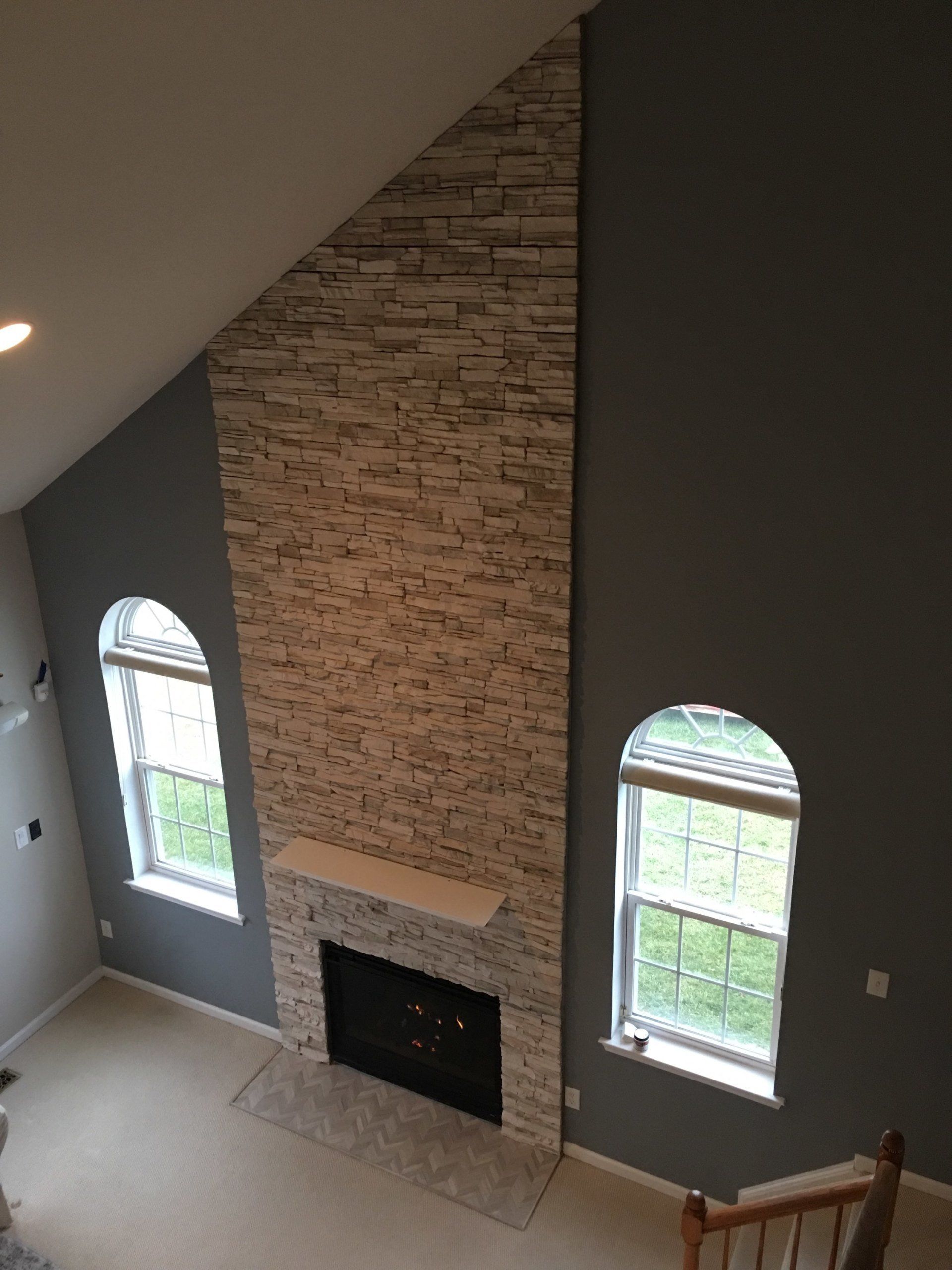 Daybreak stack stone fireplace with tile hearth