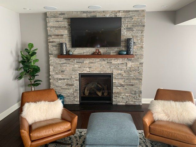 Echo ridge stack ledgestone fireplace with black granite hearth