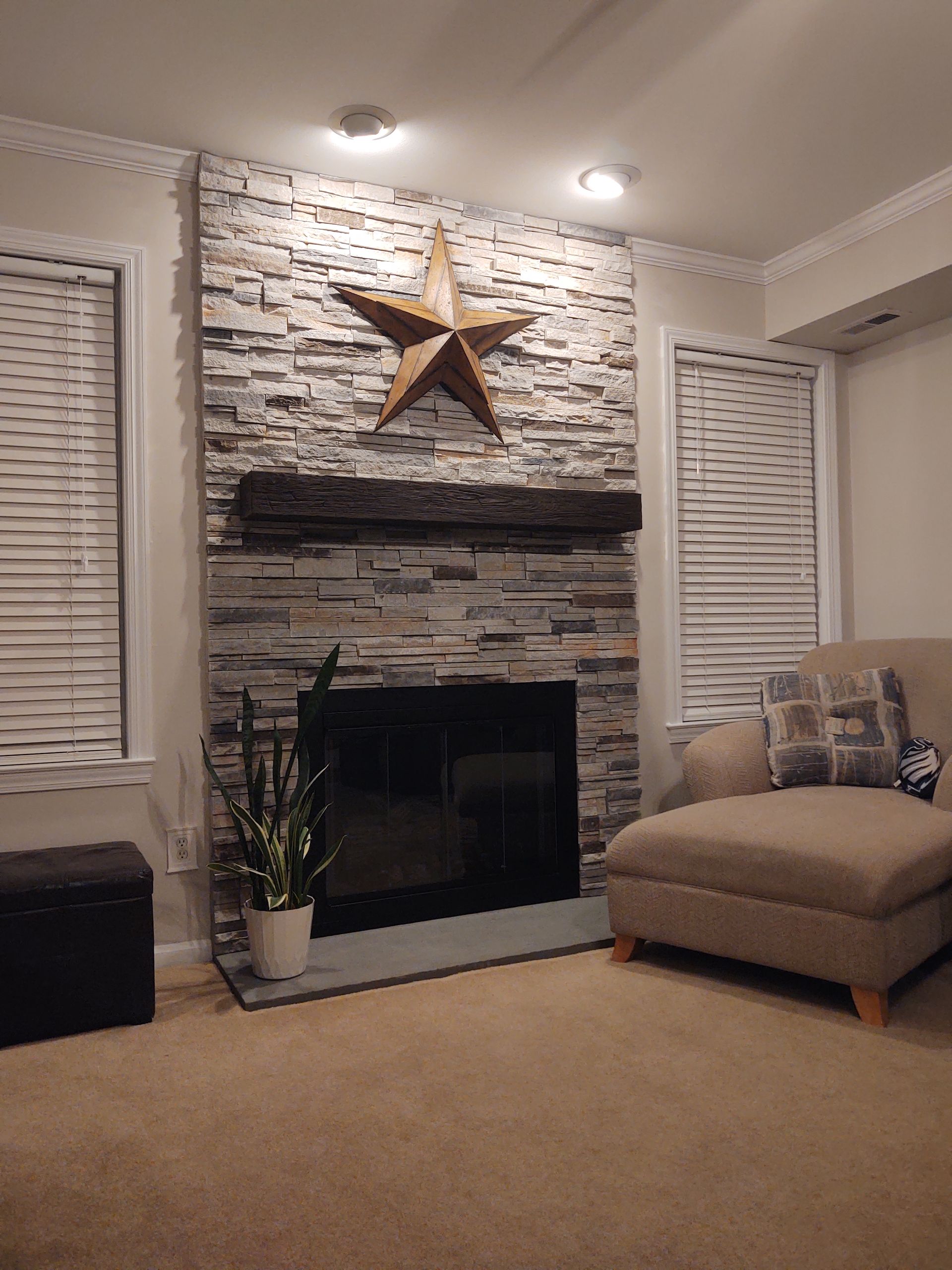 A living room with a fireplace and a star on the wall