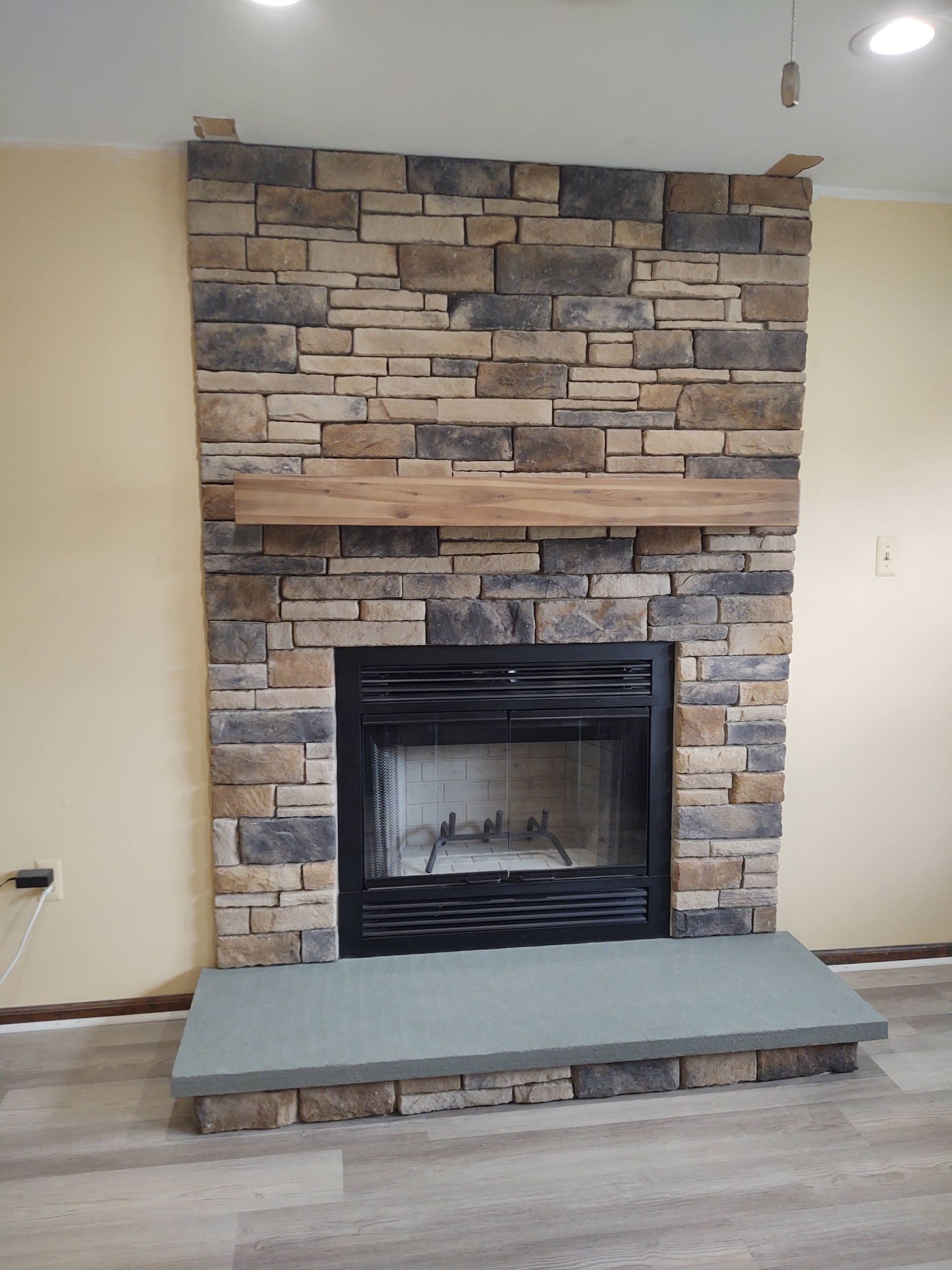 Ledgestone Fireplace — Modern Fireplace With Brick Wall in Lan ghorne, PA